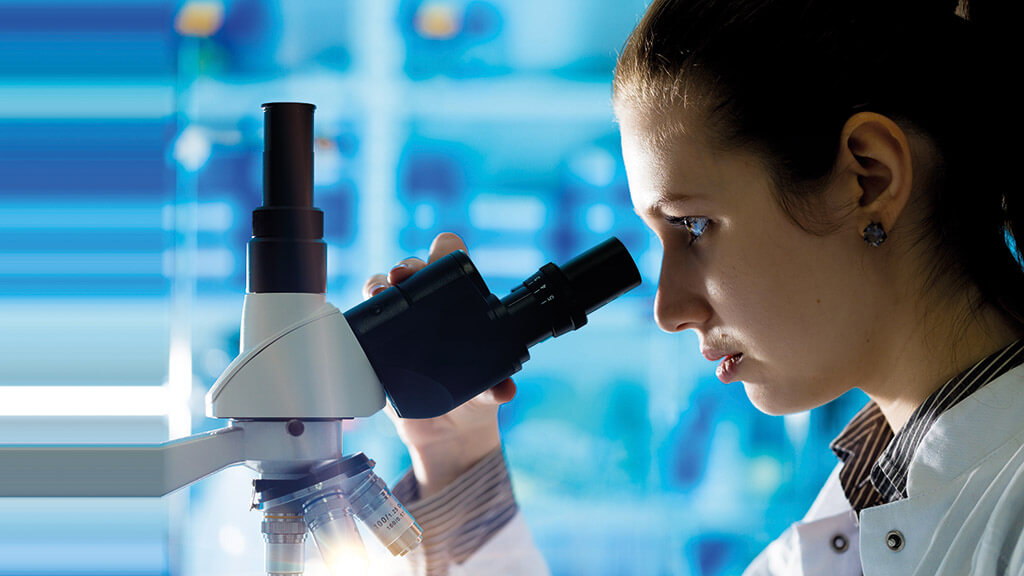 Woman using microscope