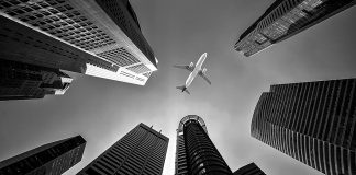 Skyscrapers with aircraft in sky