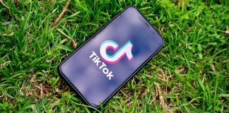 Tik Tok app on phone, grass background