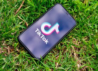 Tik Tok app on phone, grass background