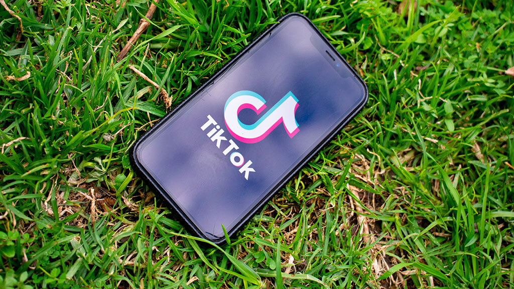 Tik Tok app on phone, grass background