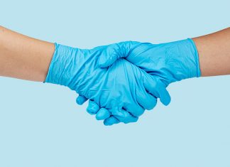 Shaking hands with blue latex gloves (Image by rawpixel.com)