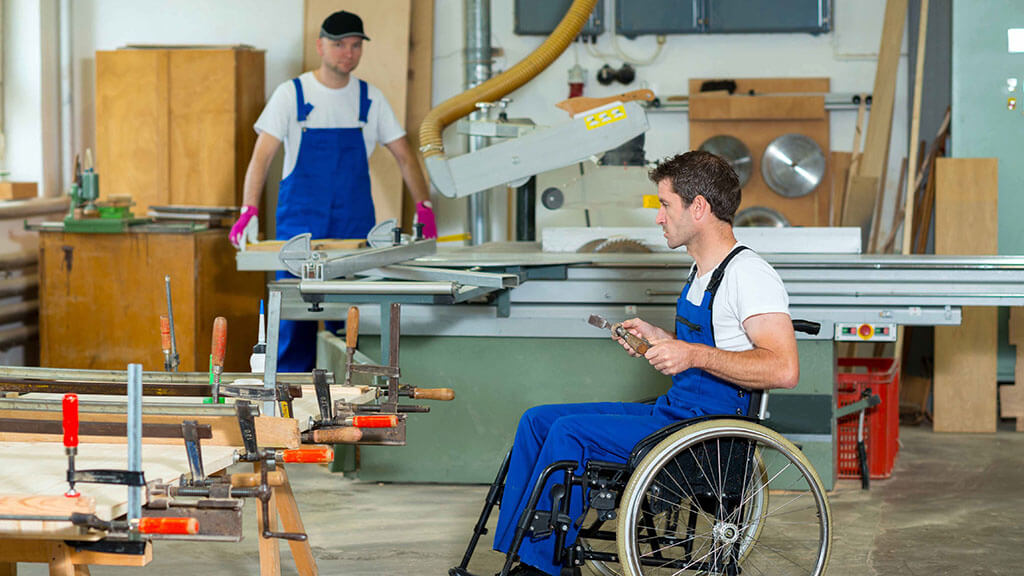 Man with disability working in factory