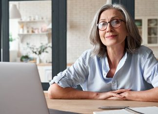 Older businesswoman behind desk