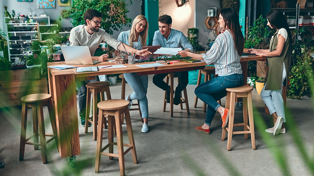 People meeting around table in boutique office