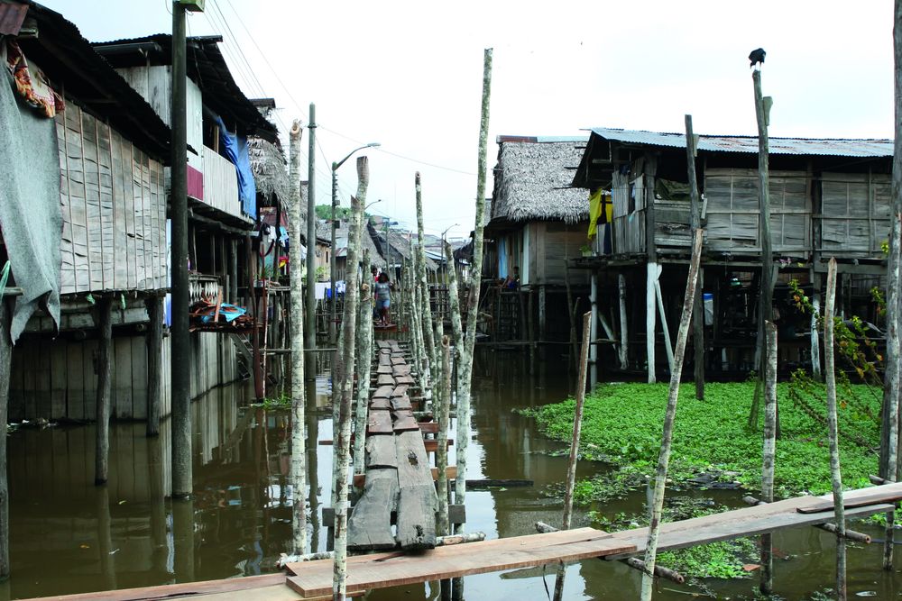 Houses on stilts above polluted water, Peru