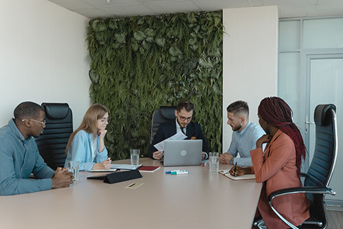 Company meeting room, living wall in background, biophilic design