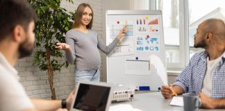 Pregnant businesswoman giving presentation, women's health in the workplace