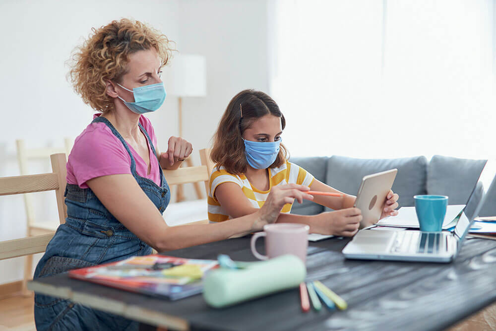 Woman home-schooling child, working from home