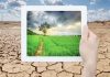 Climate tech: tablet with drought landscape background