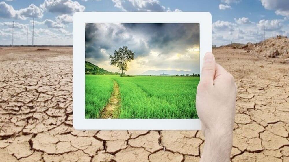 Climate tech: tablet with drought landscape background