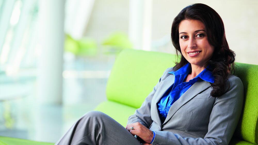 Woman in formal business wear, sitting