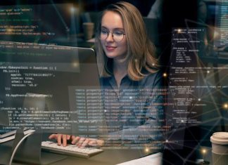 Woman working on computer, programming.