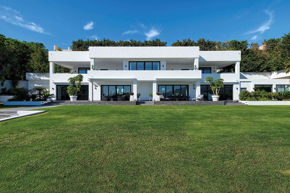 Spanish property market: modern house with lawn and blue sky