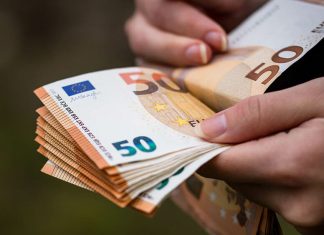 Closeup female hands counting 50 Euro banknotes